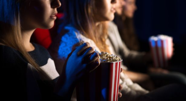 Ex-Odeon worker shares worst discoveries – from used condoms to cups of pee Teenager friends at the cinema watching a movie together and eating popcorn, beautiful girl on foreground, movies and entertainment concept