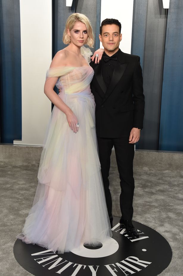 Inside Rami Malek's life – Bond villain, co-star romance and Bohemian Rhapsody Lucy Boynton (L) and Rami Malek attend the 2020 Vanity Fair Oscar Party