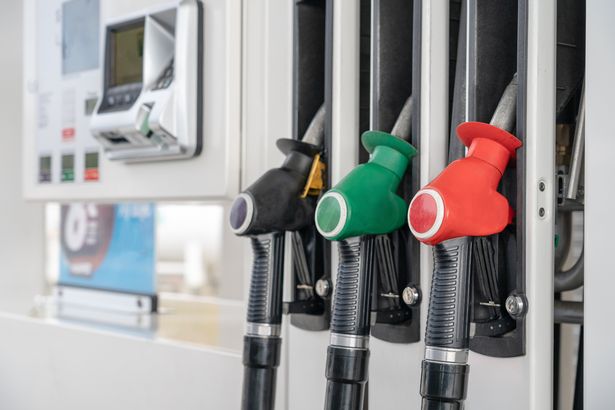 Fuel shortage: What happens if you run out of petrol – and how much can you be fined? Red green black colour fuel gasoline dispenser background