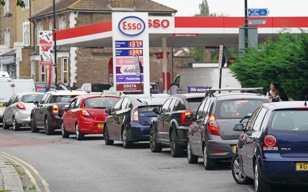Petrol stations to set £30 fuel limit after panic-buyers storm pumps Motorists queue for petrol at an Esso petrol station in Brockley, South London.