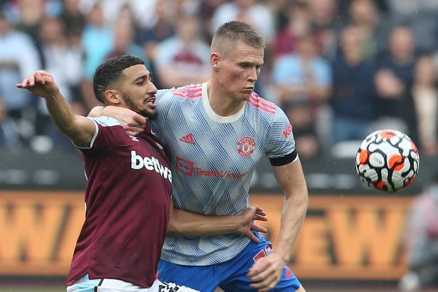 Man Utd fans beg club to sign "missing piece" Declan Rice after West Ham display Scott McTominay fights for the ball at the London Stadium