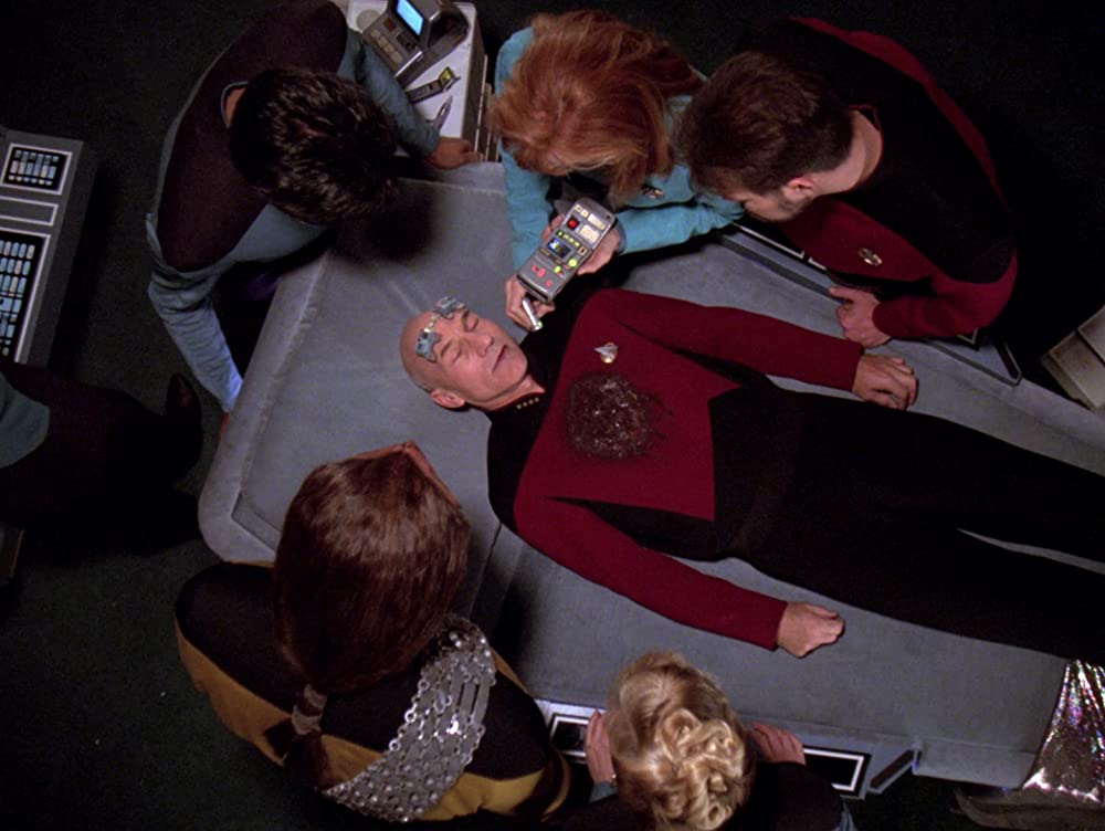 1. Sticking to His Life Decisions (Tapestry S6): Picard died in the infirmary after a life-threatening injury. A divine Star Trek entity, Q, spared his mind and gave him a second chance at life. Picard went back and tried to correct his mistakes, but he ended up as a lieutenant in the substructure of the Enterprise. He begged Q to make things right and Q agreed to spare his life.